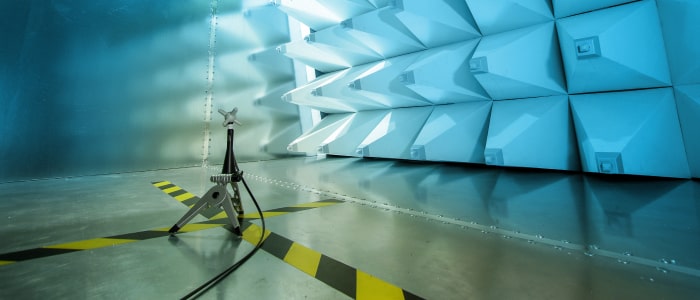 An anechoic chamber used for EMI and EMC testing, featuring specialized acoustic panels and equipment to measure electromagnetic interference and ensure the compatibility of electronic devices.